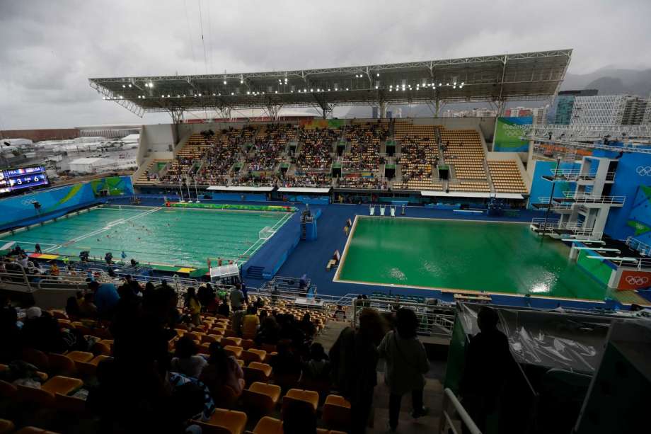 The water of the diving pool at right appears a murky green as the water polo pool at left appears a greener colour than the previous day during a preliminary round match between United States and France in the Maria Lenk Aquatic Center at the 2016 Summer