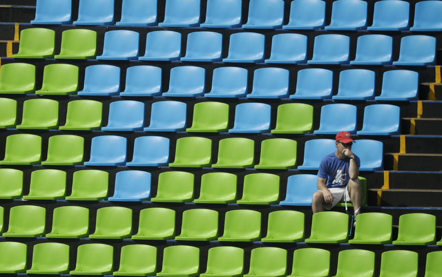 ASSOCIATED PRESS           A fan sits surround by empty seats at the equestrian eventing dressage competition at the 2016 Summer Olympics in Rio de Janeiro Brazil Sunday Aug. 7 2016