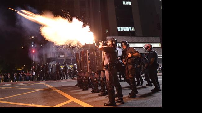 Riot police fire tear gas grenades at supporters of suspended president Dilma Rousseff in Sao Paulo