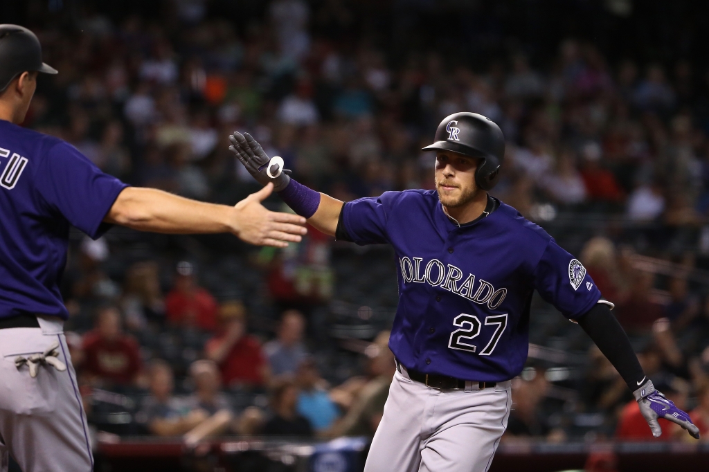 Trevor Story #27 of the Colorado Rockies high fives DJ Le Mahieu #9 after hitting a two run home-run against the Arizona Diamondbacks during the first inning of the MLB game at Chase Field