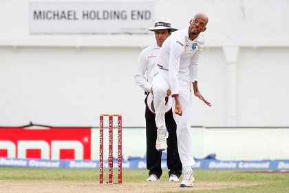 Roston Chase sends down a delivery during his five-wicket haul against India during the second Test at Sabina Park