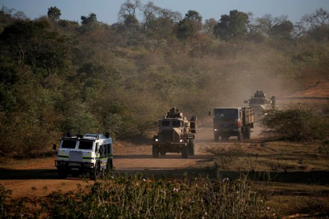 Members of the South African National Defence Force drive behind a police Nyala as they patrol a village during tense local municipal elections in Vuwani South Africa's northern Limpopo province