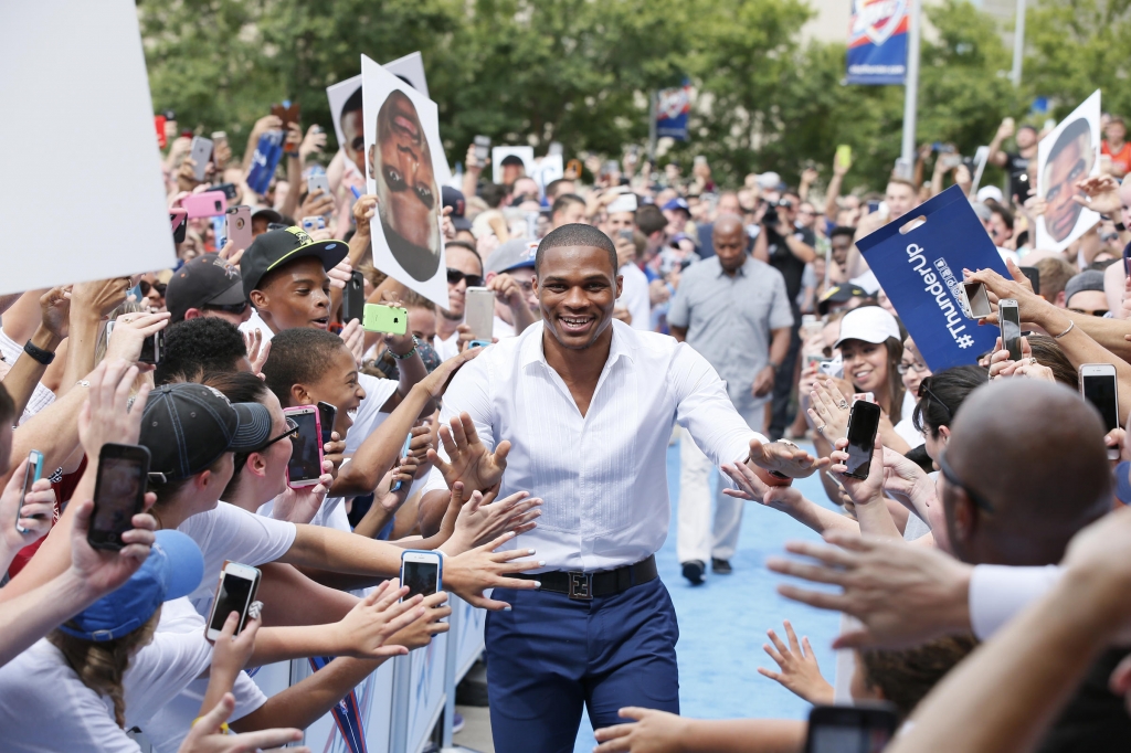 Oklahoma City Thunder guard Russell Westbrook is greeted by fans as he arrives for a news conference to announce that he has signed a contract extension with the Thunder in Oklahoma City Thursday Aug. 4 2016