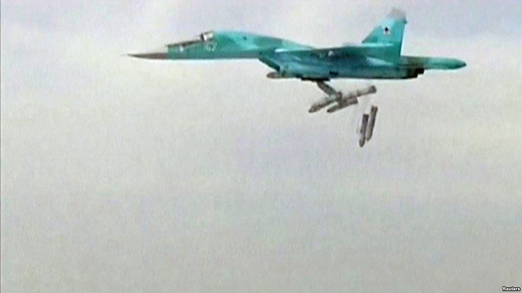 A still image taken from video footage and released by Russia's Defence Ministry on August 18 shows a Russian Sukhoi Su-34 fighter bomber based at Iran's Hamadan air base dropping bombs in the Syrian province of Deir ez-Zor