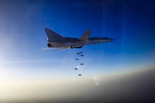 An image provided by Russia's Defense Ministry shows a Russian Tu-22 M3 dropping bombs over Aleppo Syria on Tuesday