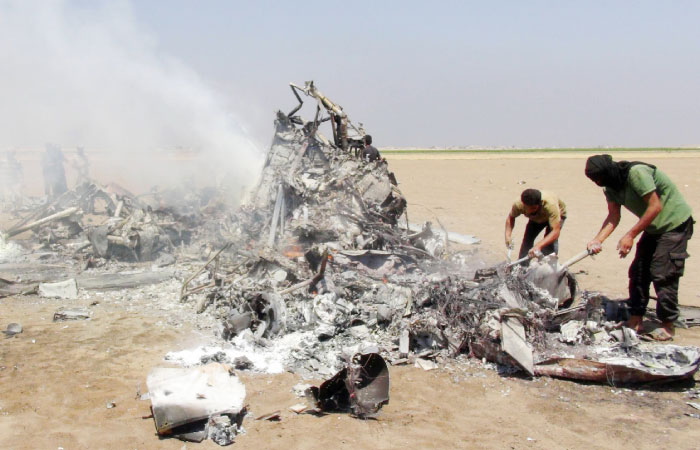 1 reportedly shows Syrian rebels inspecting the wreckage of a Russian Mi-8 military transport helicopter after it was shot down along the administrative border between Idlib province northwestern Syria and neighboring Aleppo