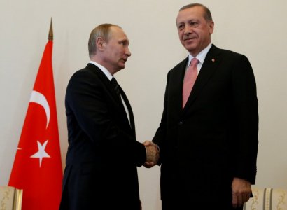 Russian President Vladimir Putin shakes hands with Turkish President Tayyip Erdogan during their meeting in St. Petersburg Russia