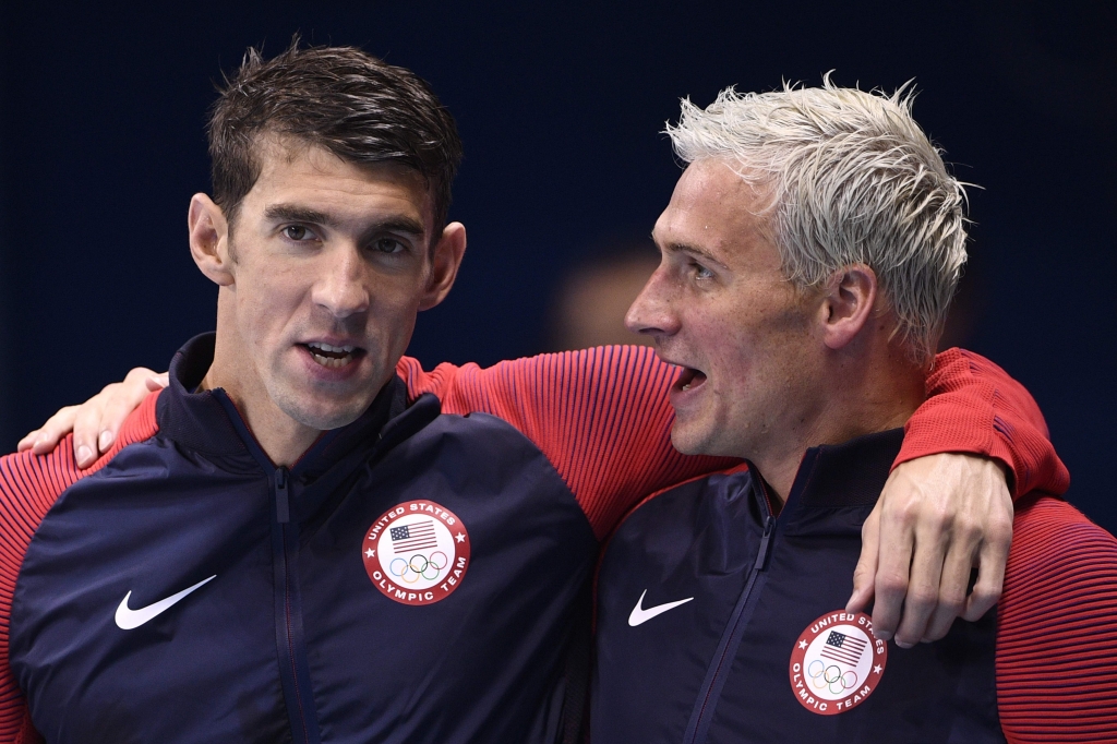 USA's Michael Phelps and USA's Ryan Lochte celebrate on the podium after they won the Men's 4x200m Freestyle Relay Final during the swimming event at the Rio 2016 Olympic Games at the Olympic Aquatics Stadium in Rio de Janeiro on August