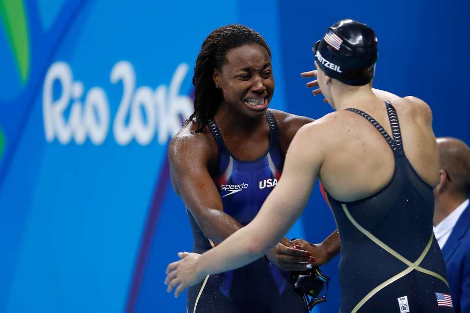 RIO DE JANEIRO BRAZIL- AUGUST 11 Simone Manuel of the United States embraces Abbey Weitzeil of the United States after winning gold in the Women's 100m Freestyle Final on Day 6 of the Rio 2016 Olympic Games at the Olympic Aquatics Stadium on August 11