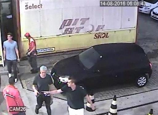 In this Sunday Aug. 14 2016 frame from surveillance video released by Brazil Police swimmer Ryan Lochte second from right of the United States and teammates appear at a gas station during the 2016 Summer Olympics in Rio de Janeiro Brazil. A