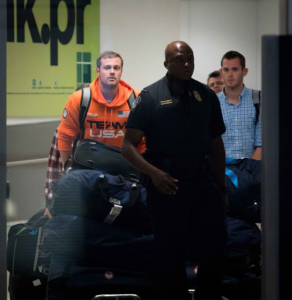 MIAMI FL- AUGUST 19 USA National Swimming Team members Jack Conger and Gunnar Bentz are escorted through the International terminal at Miami International Airport upon their arrival to the United States from Rio de Janeiro Brazil