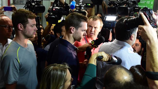 American swimmers Gunnar Bentz and Jack Conger leave the police station at the Rio de Janeiro International Airport after being detained on the plane that would travel back to the US