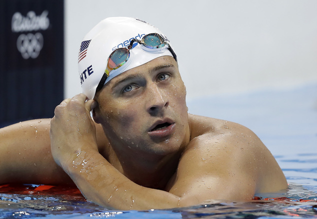 United States Ryan Lochte checks his time in a men's 4x200-meter freestyle heat during the swimming compet