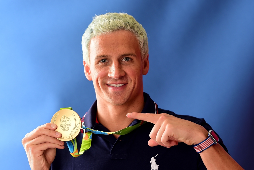 Ryan Lochte poses with his gold medal on the Today show set on Copacabana Beach last week