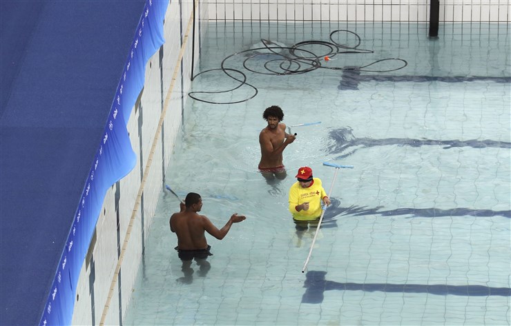 STEFAN WERMUTH  Reuters   Technicians and lifeguards drain water from the synchronized swimming pool before it is replaced