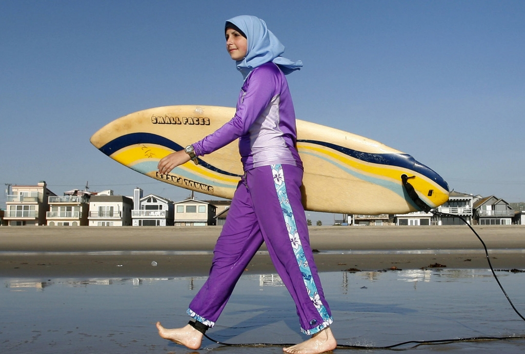 Sama Wareh walks along a California beach in swimwear designed for Muslim women