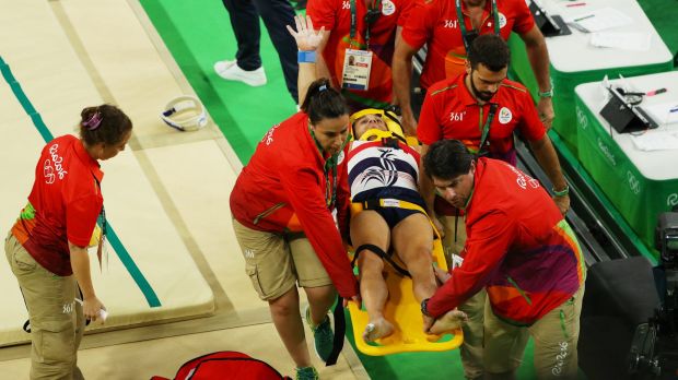 Samir Ait Said of France raises his arm as he is stretchered off after breaking his leg