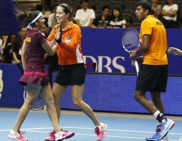 Team Micromax Indian Aces&#039 Ana Ivanovic of Serbia celebrates with teammates Sania Mirza and Rohan Bopanna of India after their mixed doubles match against UAE Royals at the International Premier Tennis League in Singapore