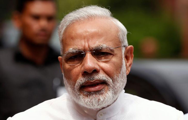 India's Prime Minister Narendra Modi speaks to the media inside the parliament premises on the first day of the monsoon session in New Delhi