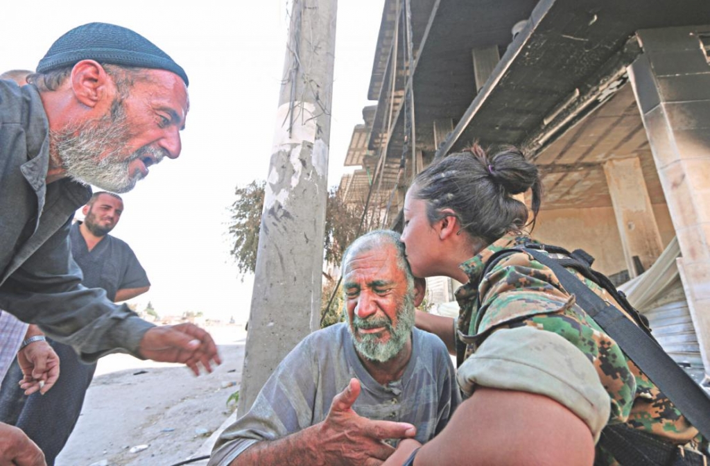 Scenes of jubilation and defiance. An SDF fighter kisses a crying man