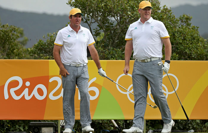 Scott Hend and Marcus Fraser of Australia watch their drives during a training session in Rio de Janeiro Monday. — Reuters