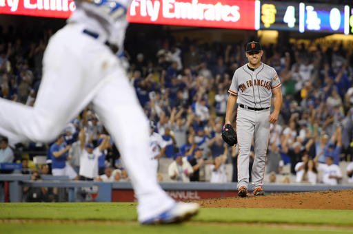 San Francisco Giants starting pitcher Matt Moore right looks toward first as Los Angeles Dodgers Corey Seager runs after Seager broke up his no-hitter with two outs in the ninth inning of a baseball game Thursday Aug. 25 2016 in Los Angeles. The Gi