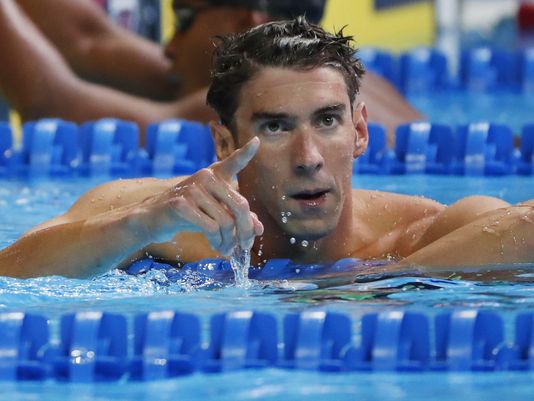 Michael Phelps reacts after the men's 100m butterfly finals in the U.S. Olympic swimming team trials at Century Link Center