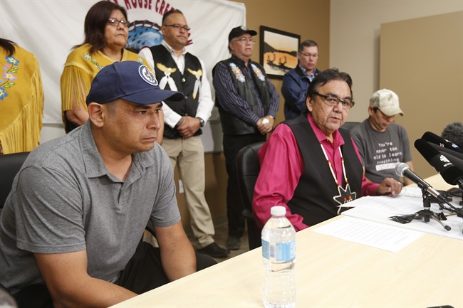 Manitoba's former aboriginal affairs minister Eric Robinson centre with Norway House residents Leon Swanson left and David Tait Jr. announces at a press conference in Winnipeg on Friday