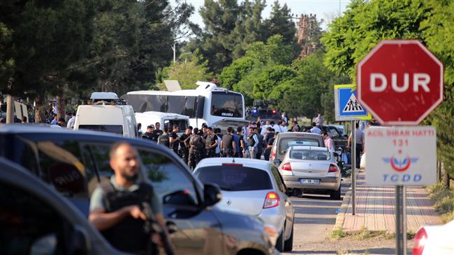 Security officers secure the area after a car bomb struck a bus in Diyarbakir Turkey