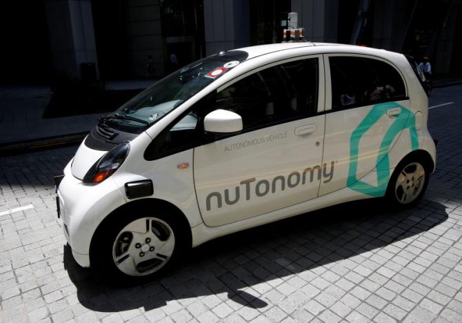 A nu Tonomy self-driving taxi drives on the road in its public trial in Singapore