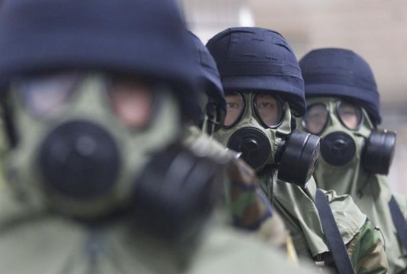 South Korean police officers wearing gas masks conduct