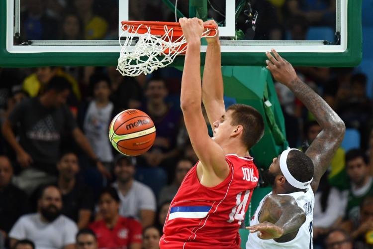 Serbia's Nikola Jokic throws down a dunk ahead of USA's De Marcus Cousins