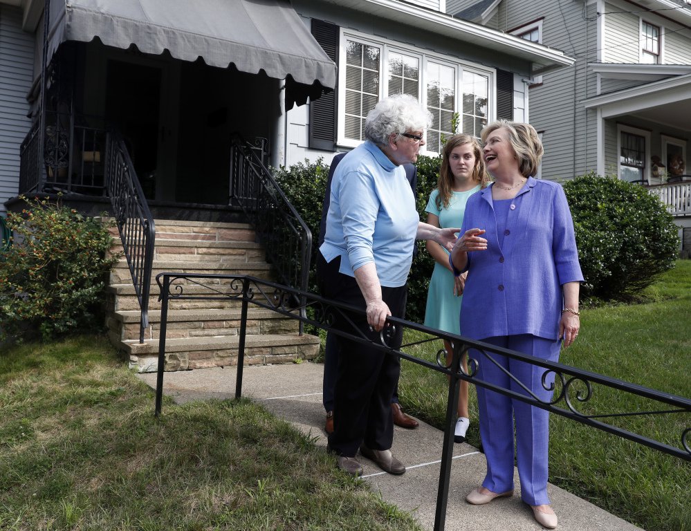 Democratic presidential candidate Hillary Clinton talks with Anne Kearns left as she and Vice President Joe Biden visit Biden's childhood home in Scranton Pa. on Monday