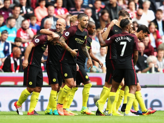 Sergio Aguero celebrating with team mates after scoring against Stoke