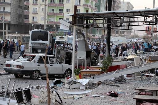 Police search an area after a bomb attack in Mardin Turkey Wednesday Aug 10 2016. A wave of Kurdish rebel attacks targeting police and soldiers in Turkey's mainly Kurdish southeast killed at least 12 people on Wednesday as Turkey was still dealing