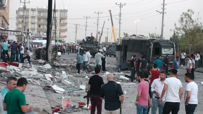 Police search an area after a bomb attack in Mardin Turkey Wednesday Aug 10 2016. A wave of Kurdish rebel attacks targeting police and soldiers in Turkey's mainly Kurdish southeast killed at least 12 people on Wednesday as Turkey was still dealin