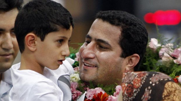 Shahram Amiri greets his son Amir Hossein after arriving back in Iran in July 2010