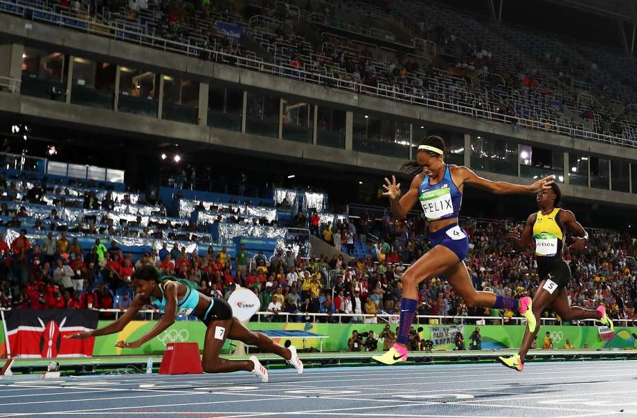 Shaunae Miller of the Bahamas lays out to cross the finish line just ahead of American Allyson Felix in the 400 meters