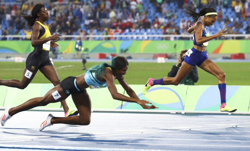 Shaunae Miller of the Bahamas dives over the finish line past Shericka Jackson of Jamaica and Allyson Felix of the USA, in the women's 400 meter race at the Rio Olympics on Monday