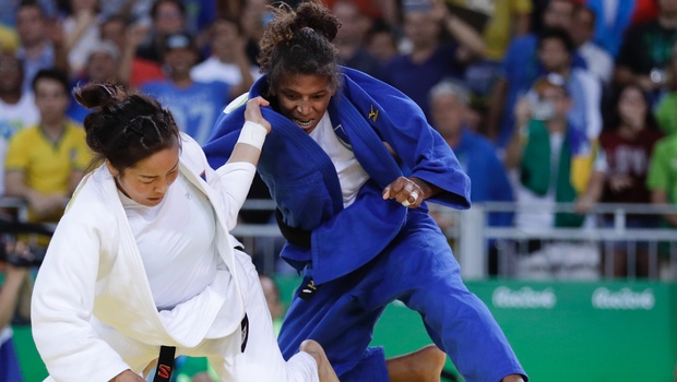 Brazil's Rafaela Silva blue competes with Mongolia's Sumiya Dorjsuren for the gold medal of the women's 57-kg judo competition at the 2016 Summer Olympics in Rio de Janeiro Brazil. | AP