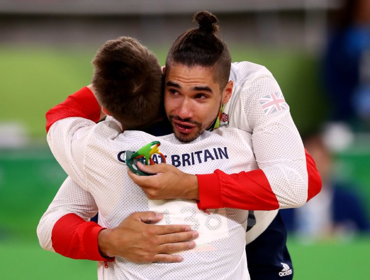 Silver medalist Louis Smith hugs Team GB teammate Max Whitlock who won gold in the men's Pommel Horse final