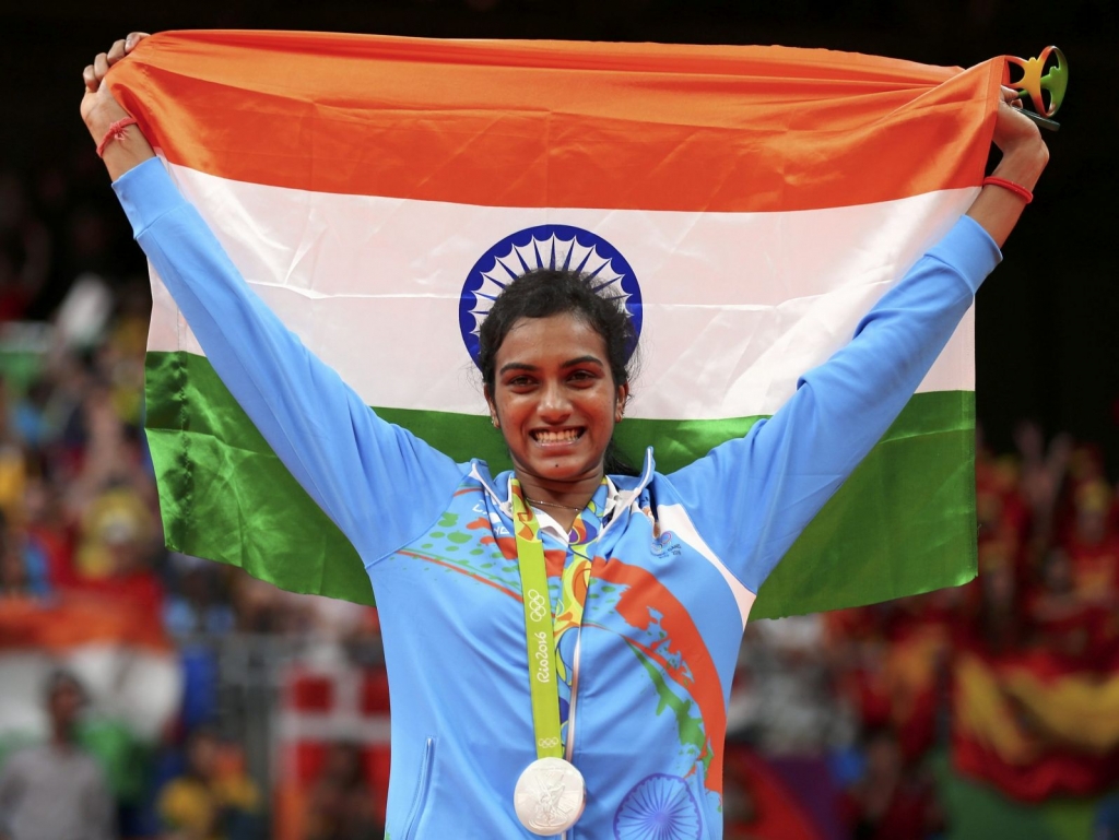 Silver medallist PV Sindhu of India poses with an Indian national flag. REUTERS  Marcelo del Pozo