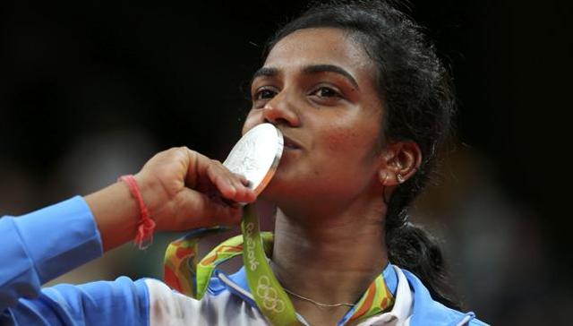 Silver medallist PV Sindhu of India poses kissing her medal