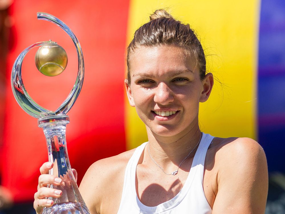 Simona Halep of Romania hoists the Rogers Cup after defeating American Madison Keys in the final at Uniprix Stadium in Montreal