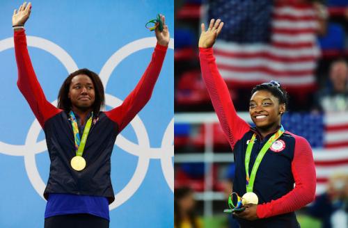 Simone Manuel and Simone Biles in red and navy warm-ups with gold medals on green ribbons