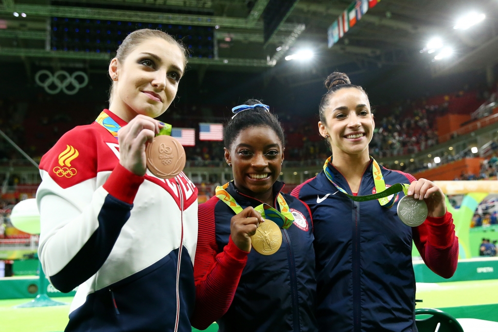 Bronze medalist Aliya Mustafina of Russia gold medalist Simone Biles of the United States and silver medalist Alexandra Raisman of the United States pose for