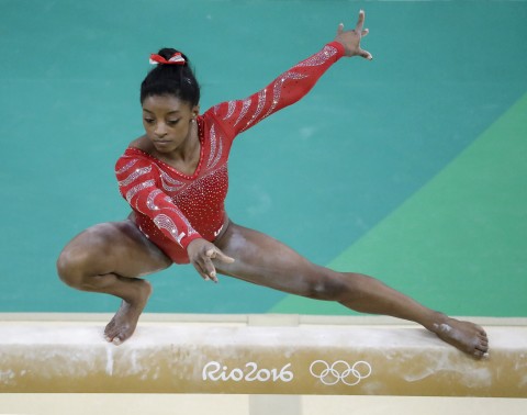 Simone Biles trains on the balance beam