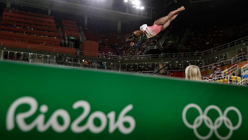 United States Simone Biles bites her gold medal