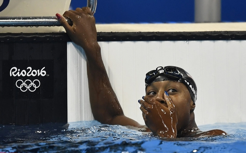 United States&#039 Simone Manuel celebrates after winning the gold medal in the women's 100-meter freestyle final during the swimming competitions at the 2016 Summer Olympics Thursday Aug. 11 2016 in Rio de Janeiro Brazil. (AP