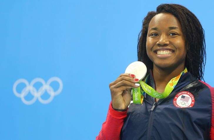 2016 Rio Olympics- Swimming- Victory Ceremony- Women's 50m Freestyle Victory Ceremony- Olympic Aquatics Stadium- Rio de Janeiro Brazil- 13/08/2016. Simone Manuel of USA poses with her medal. REUTERS  Dominic Ebenbichler